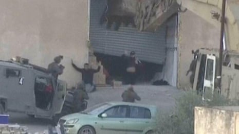 Moment Israeli forces shoot dead surrendered Palestinians – video report