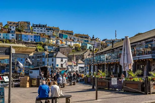 Brixham, UK. 11 April 2025. People quayside in Brixham