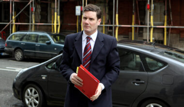 GettyImages 97051158 featuring a dynamic business meeting with professionals engaged in a lively discussion around a confe...