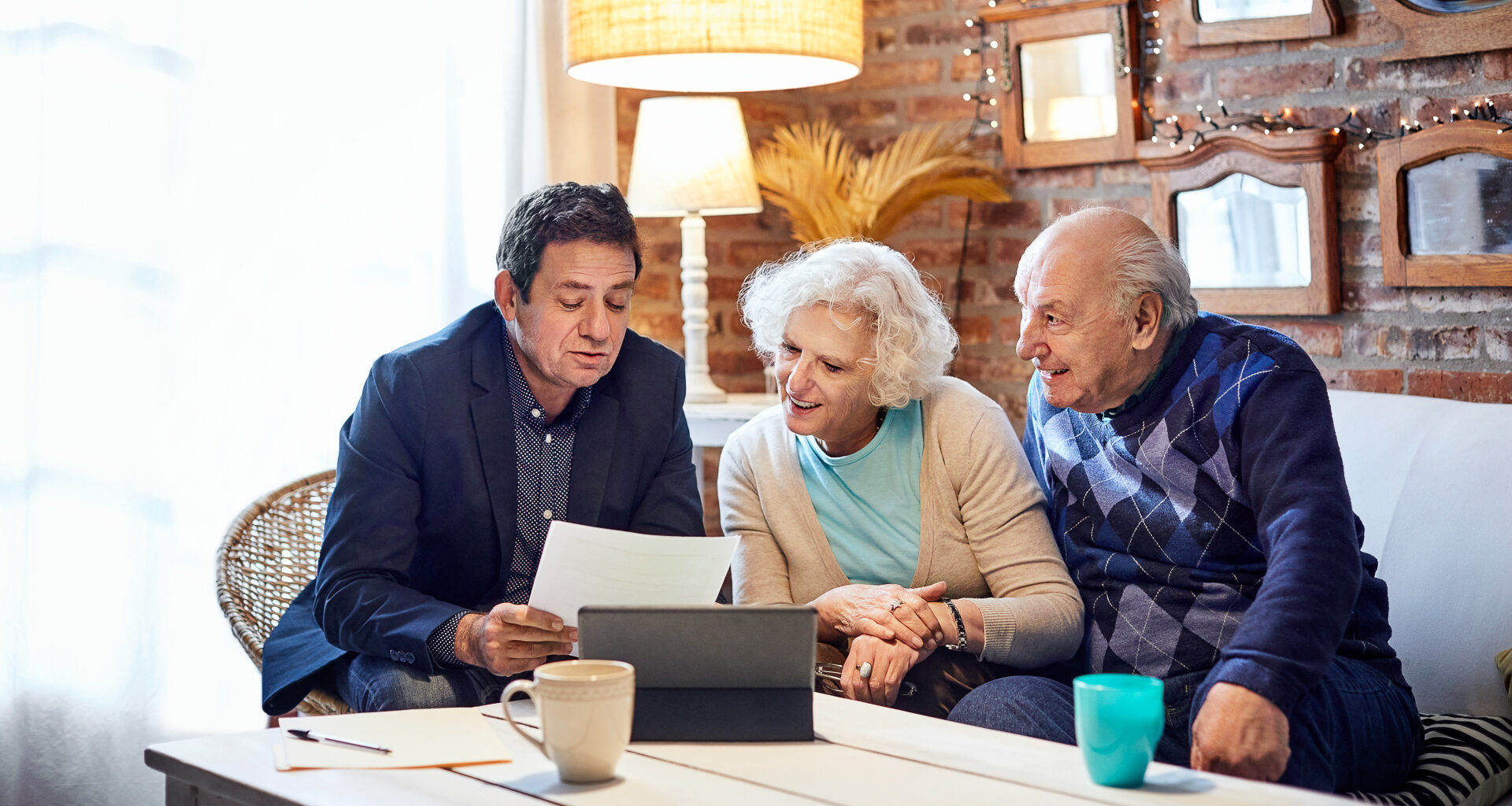 Financial advisor explaining senior couple at home.