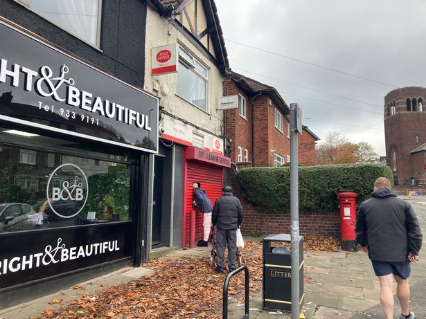 Queues for the cashpoint at the shuttered Watts Lane Post Office, Bootle.