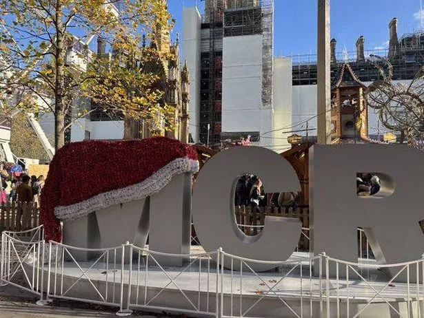 A sign saying MCR and the M has a christmas hat on