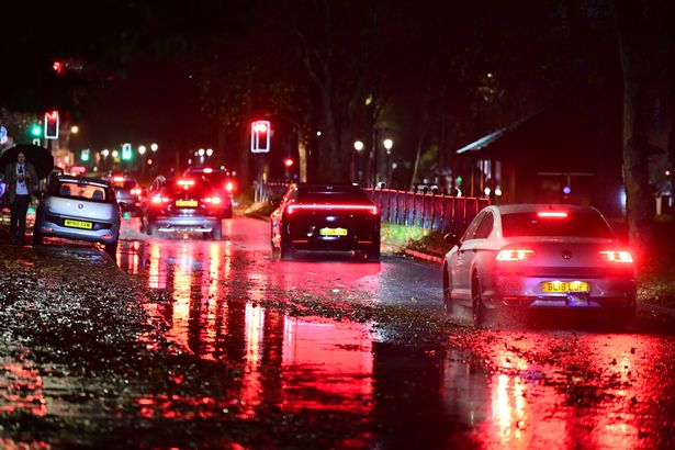 Motorists driving along the flooded Princes Road