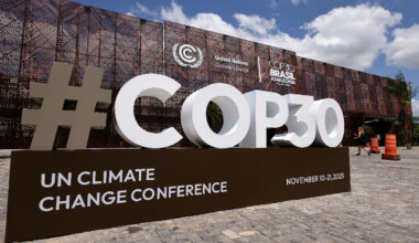 Delegates discussing climate policies at COP30 summit 2023, highlighting international efforts for sustainable development.
