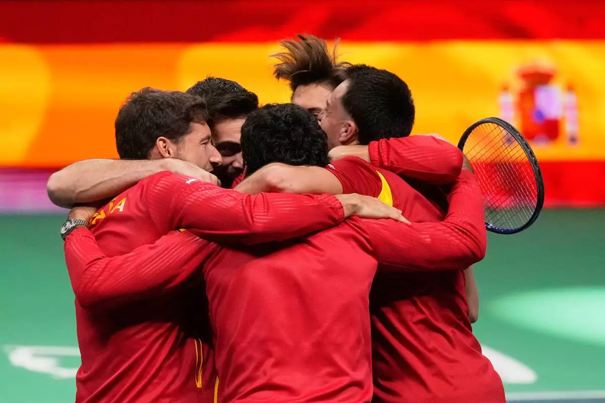 Spain's Marcel Granollers and Pedro Martinez celebrate with their teammates after winning against Germany's Kevin Krawietz and Tim Puetz during a Davis Cup double semifinal tennis match between Spain and Germany, in Bologna, Italy, Saturday, Nov. 22, 2025. (AP Photo/Luca Bruno)