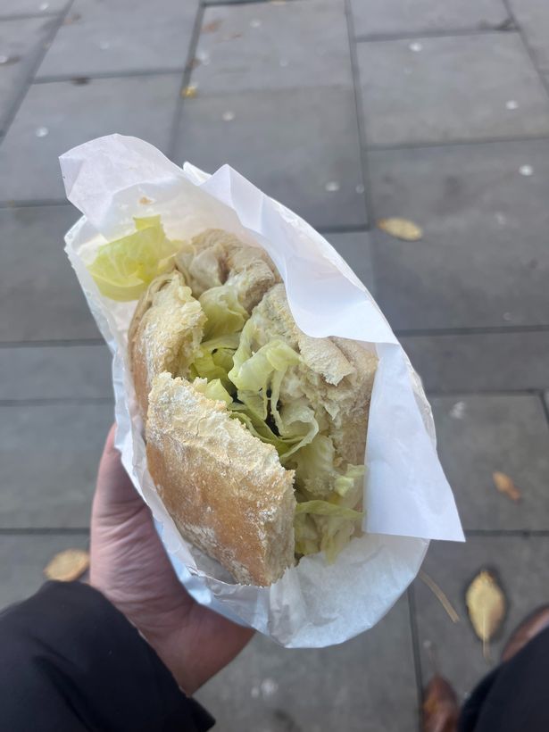 A chicken club sandwich on white bread