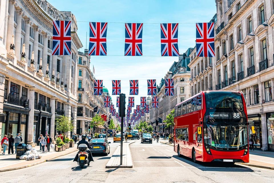 Union Jacks on Oxford Street alomng with a red London bus.