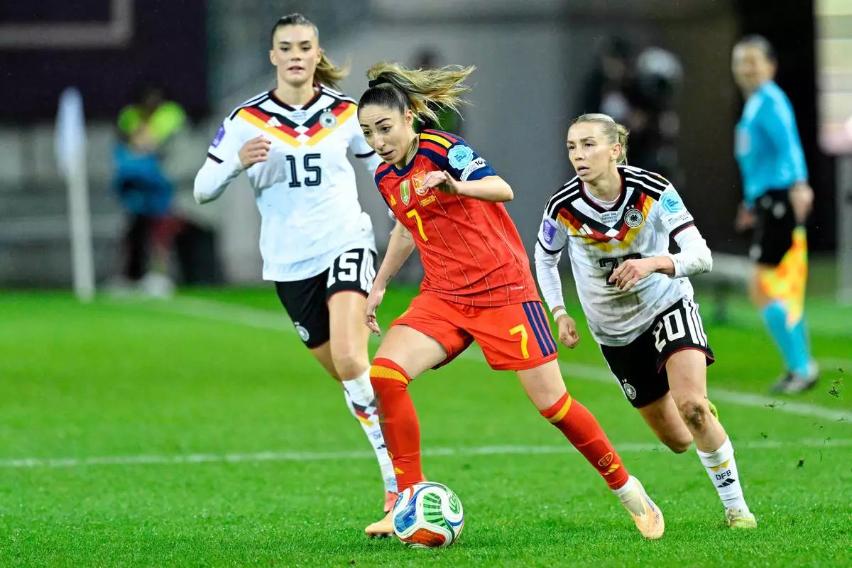 Germany's Selina Cerci, left, and Elisa Sens chase Spain's Olga Carmona, centre, during the women's nations league soccer match between Germany and Spain in Kaiserslautern, Germany, Friday Nov. 28, 2025. (Uwe Anspach/dpa via AP)