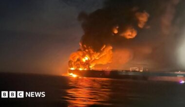 Smoke rises from two burnt-out cars in front of a shopping centre in Kyiv.
