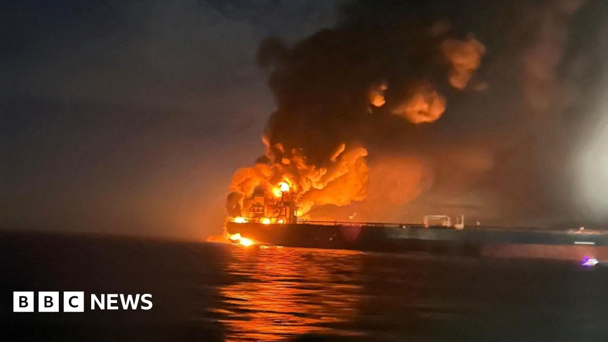 Smoke rises from two burnt-out cars in front of a shopping centre in Kyiv.
