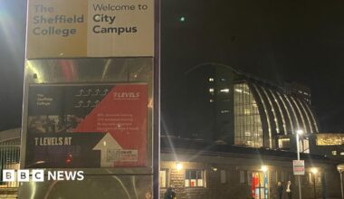 Exterior shot of Sheffield City College, with signs saying City Campus, and stone, glass and steel buildings behind.