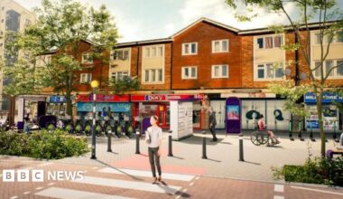 Visualisation of how the proposed road safety measures for Vauxhall and Duddeston in Birmingham would look  - showing a modernised street with local shops and bollards in place, with a zebra crossing
