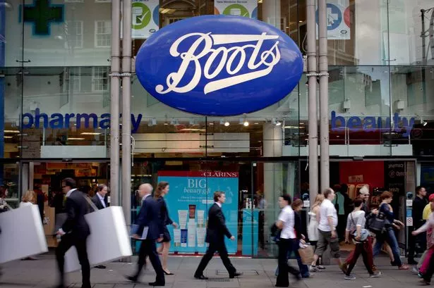Pedestrians pass a Boots store, operated by Alliance Boots, in London, U.K., on Tuesday, June 19, 2012. Walgreen Co., the largest U.S. drugstore chain, said it agreed to pay $6.7 billion for a 45 percent stake in the U.K.'s Alliance Boots as part of a deal that may see it gain full control within three years. Photographer: Jason Alden/Bloomberg via Getty Images