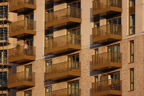 BRENTFORD, ENGLAND - OCTOBER 5: A Brentford fan stands on their balcony during the Premier League match between Brentford and Manchester City at Gtech Community Stadium on October 5, 2025 in Brentford, England. (Photo by Charlotte Wilson/Offside/Offside via Getty Images)