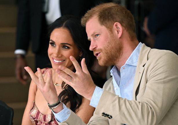 Britain's Prince Harry (R), Duke of Sussex, speaks with his wife Meghan Markle while attending a show during a visit to the National Centre for the Arts in Bogota on August 15, 2024.