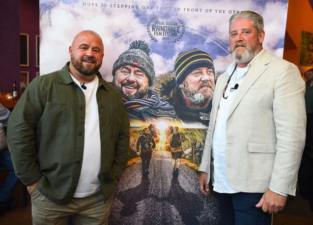 From left: John May and Tim Edwards in front of the poster for their documentary, The Two of US