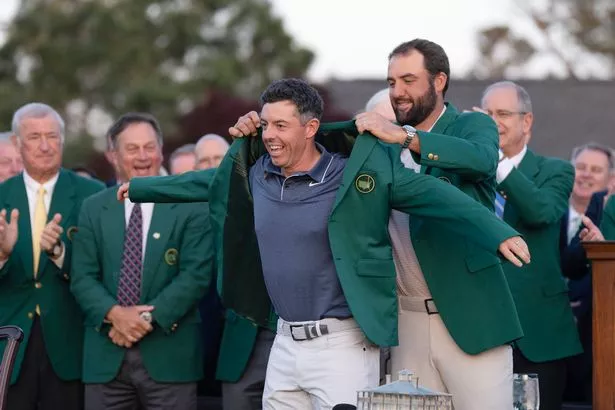 Rory McIlroy receives a Green Jacket after winning The Masters