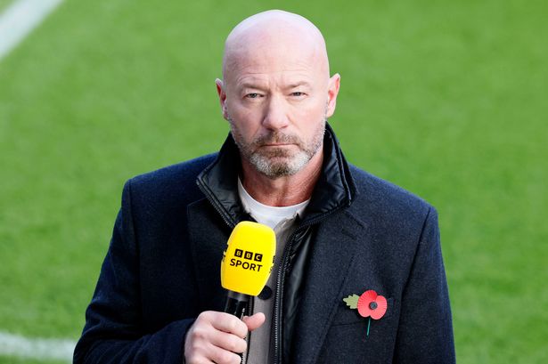 Alan Shearer speaking into a microphone.