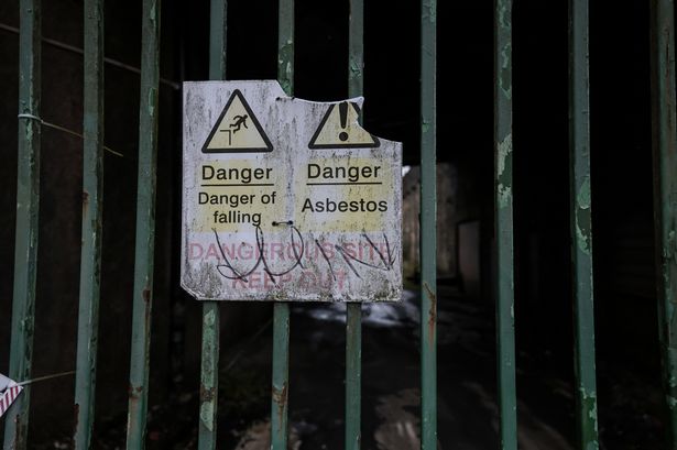 An asbestos danger sign at  former Turner Brothers Asbestos factory in Rochdale