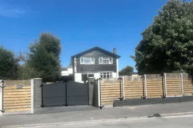 It shows the large fence at the front of the house which is almost two metres in height