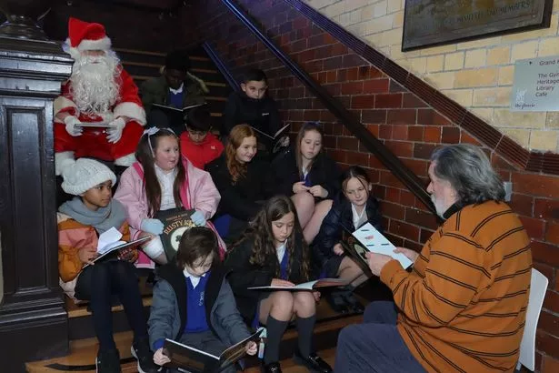 Ricky Tomlinson reads a passage from his new children's book with the students