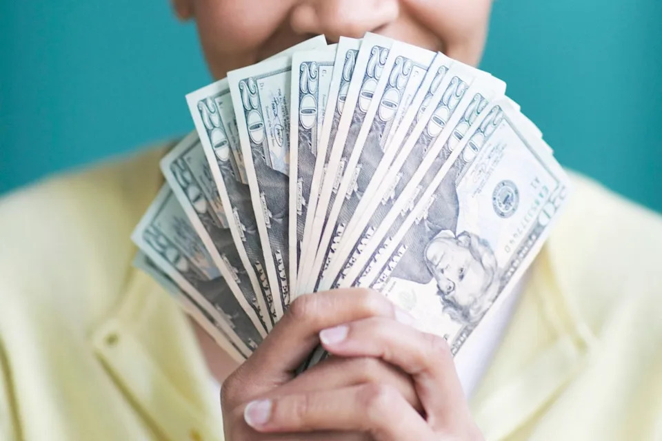 Getty Stock photo of a woman holding money