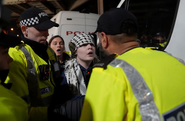 Police officers remove a pro Palestine protester outside Villa Park