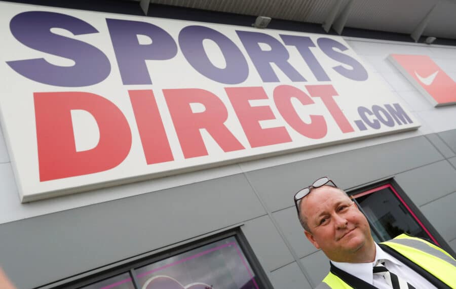 Mike Ashley, founder and majority shareholder of sportwear retailer Sports Direct, leads journalists on a factory tour after the company's AGM