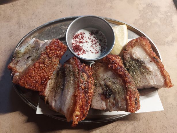 Pork belly is delicious with thick crackling and a sprinkling of herbs, but hardly a quintessential Greek dish