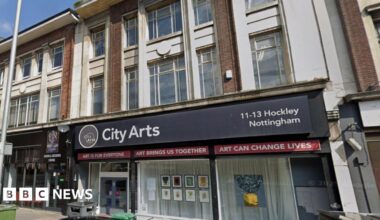 Streetview image of the City Arts building, a large glass frontage set in a three-storey brick building on a city street