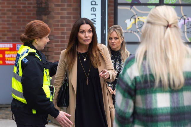 Carla confronts Lisa with Sarah and a police officer beside her in Corrie