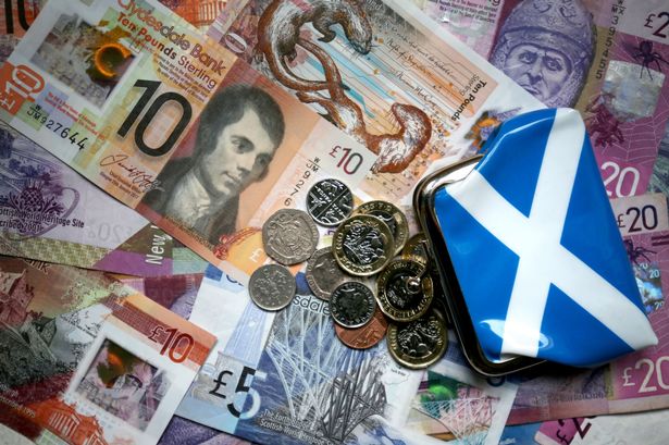 A pile of Scottish bank notes and coins. 