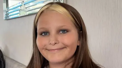 Family handout/PA Wire Collect of Mia Lucas, 12, wearing a pink jumper and smiling