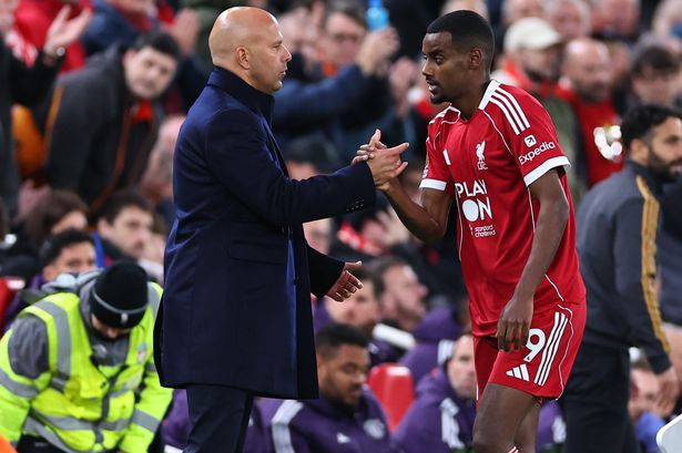 Arne Slot embraces Alexander Isak after taking the striker off in Liverpool's defeat to Manchester United