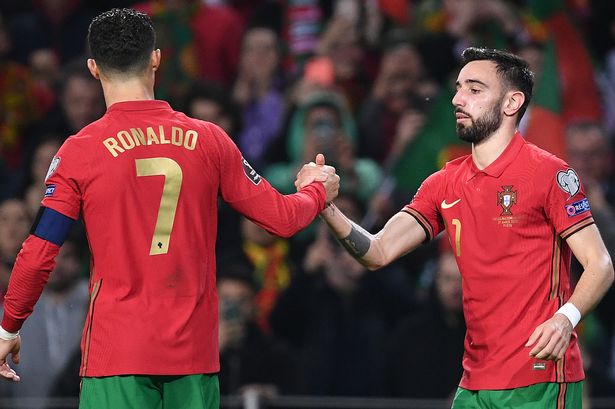 Bruno Fernandes celebrates with Cristiano Ronaldo of Portugal after scoring their team's second goal