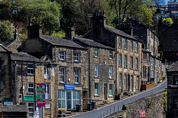 View of a row of terraced houses in the centre of Holmfirth, UK.  There are no people in the photograph
