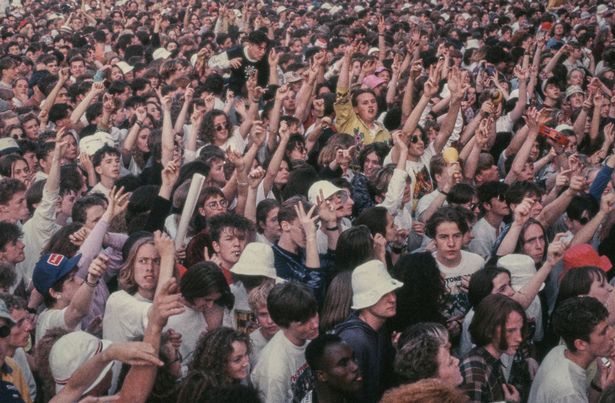 A view of the crowd at an outdoor concert given by British rock group The Stone Roses at Spike Island, Widnes, Cheshire, 27th May 1990. (Photo by Glyn Howells/Hulton Archive/Getty Images)