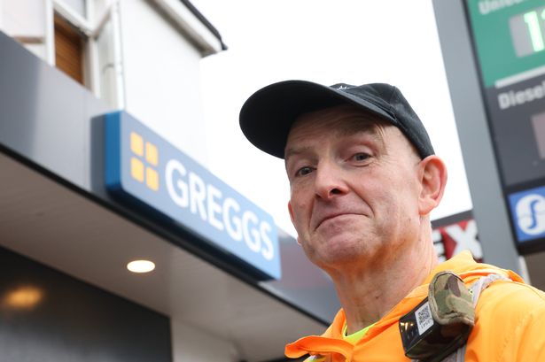 Man stood in front of GREGGS