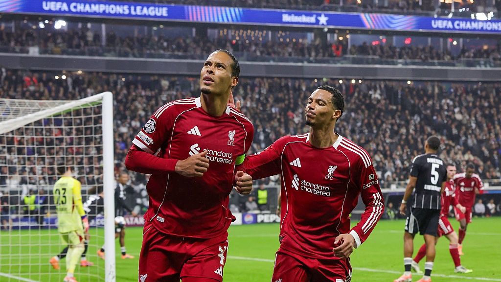Virgil van Dijk of Liverpool FC (L) celebrates with teammate Hugo Ekitike after scoring his team's second goal during the UEFA Champions League 2025/26 League Phase MD3 match between Eintracht Frankfurt and Liverpool FC at Frankfurt Stadion on October 22, 2025 in Frankfurt am Main, Germany.