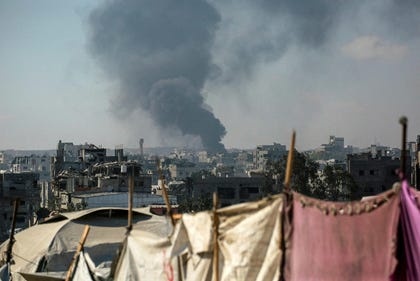Smoke billows east of Gaza City during an Israeli bombardment last July. Credit: AFP/BASHAR TALEB Smoke billows east of Gaza City during an Israeli bombardment last July.