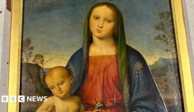 A Renaissance painting of a woman sitting down with a baby on her knee, who is also facing forwards