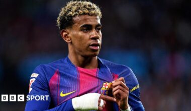 Lamine Yamal holds the Barcelona badge on his shirt