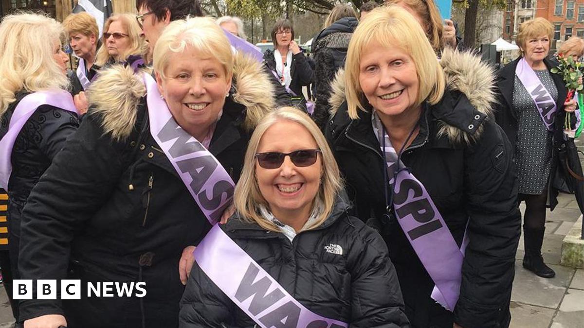 Sisters (left to right) Mary Waterhouse, Norma Elkington and Susan Dutton wearing black coats and lilac sashes with 'Waspi' written on them at a campaign rally