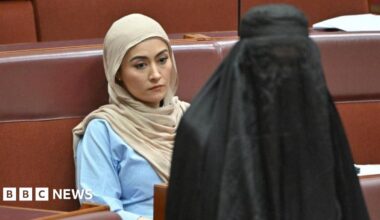 Independent senator Fatima Payman reacts as One Nation leader Pauline Hanson wears a burka in the Australian parliament