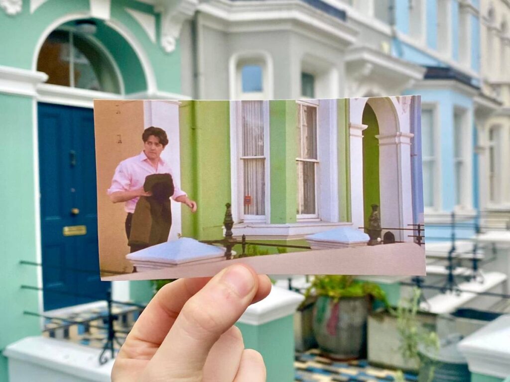 A photo of Hugh Grant in Notting Hill stepping out of a house in Notting Hill
