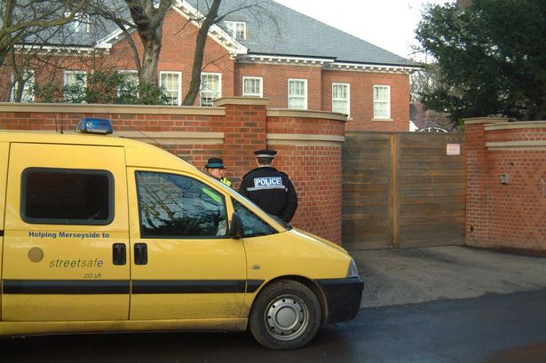 Police watch the gates of Steven Gerrard's house in Formby after the robbery