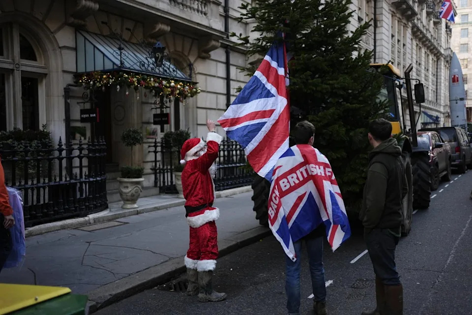 One protester dressed as Santa had a ‘naughty list’ of Government figures (Jordan Pettitt/PA)