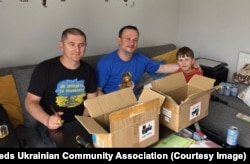 Viacheslav Semeniuk (left) with a fellow volunteer preparing for a session of dismantling disposable vapes.