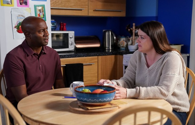 Zoe and Anthony sit at the kitchen table in EastEnders
