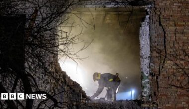 An emergency responder works at the site of an apartment building that was hit during a Russian missile and drone attack on Kyiv on 29 November 2025.